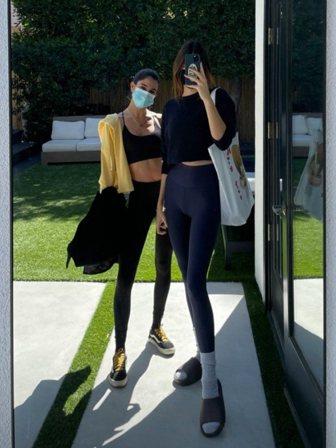 Kendall Jenner taking a selfie with Lauren Perez in a standing mirror.